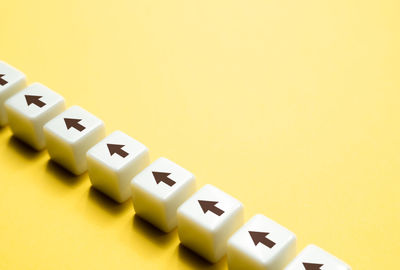 Close-up of toy blocks on yellow background