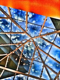 Low angle view of metallic structure against blue sky