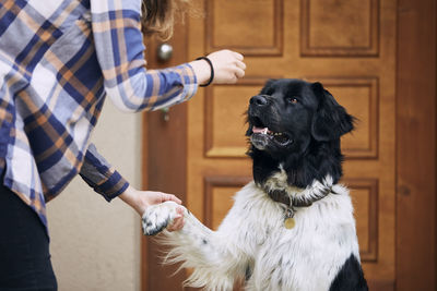 Man with dog standing at home