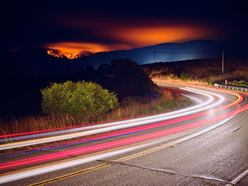 Woodward fire burning in point reyes national park, headlights on road