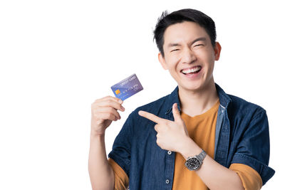 Portrait of smiling young man against white background