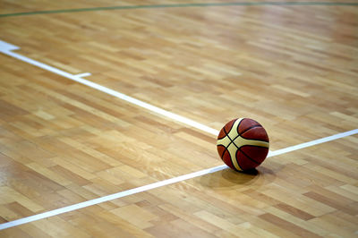 High angle view of basketball ball on hardwood floor