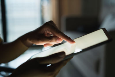 Midsection of woman using mobile phone