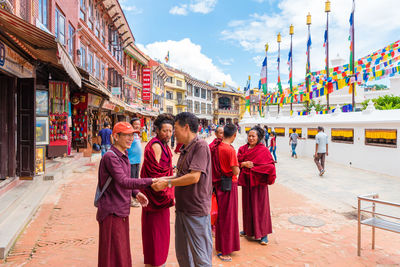 Group of people walking against building