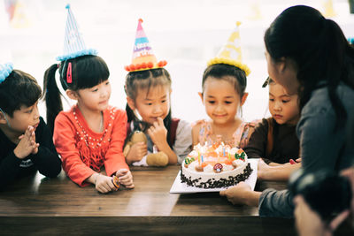 Cute happy friends enjoying birthday party at home