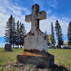 View of cross on field against sky