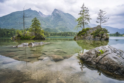 Scenic view of lake and mountains against sky