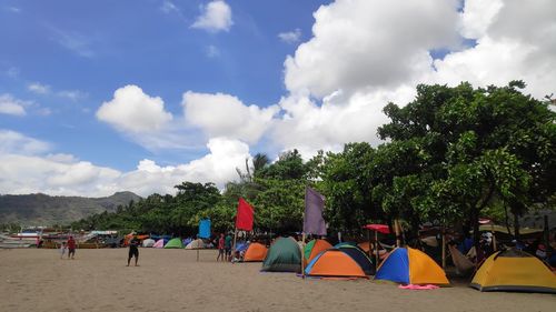 People on beach against sky