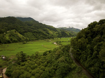 Aerial view of a village in the lush green rain cloud cover tropical rain forest mountain