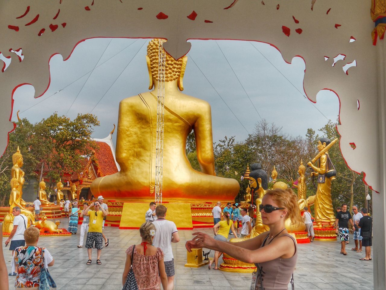 STATUE OF BUDDHA AGAINST CATHEDRAL