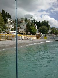 Swimming pool in city against sky