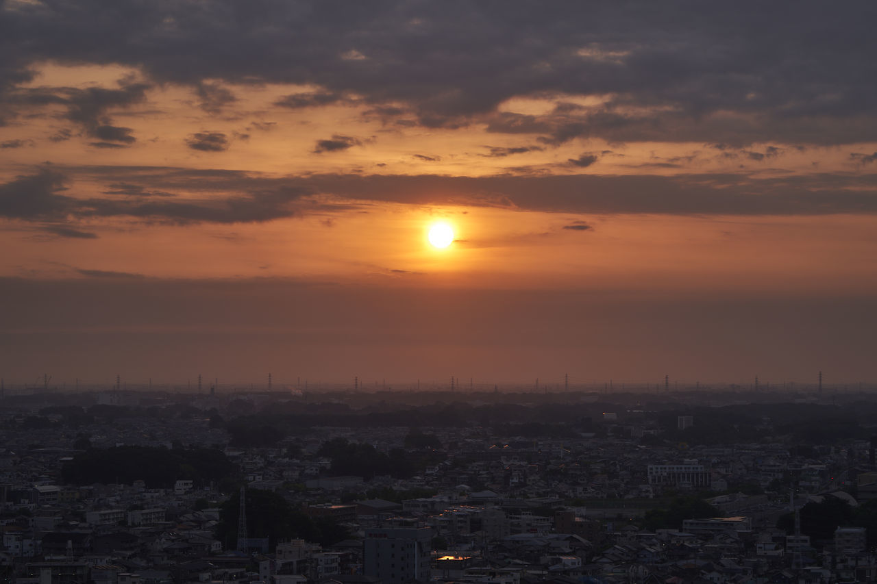 AERIAL VIEW OF CITY AGAINST ORANGE SKY