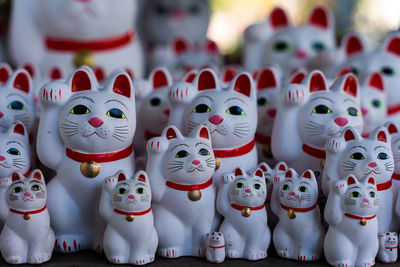 Close-up of cat figurines for sale in a japanese shrine