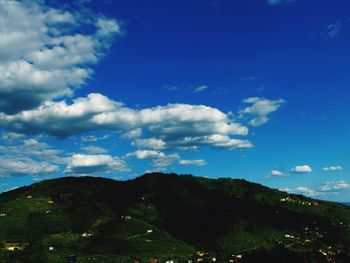 Scenic view of mountains against cloudy sky