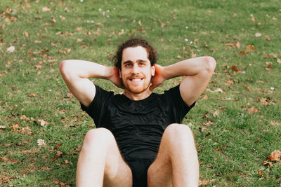 Full length of man exercising on grass