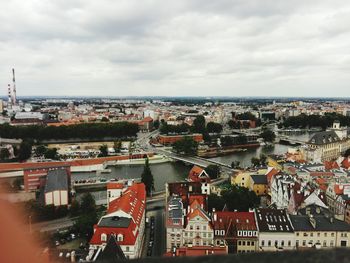 Cityscape against cloudy sky