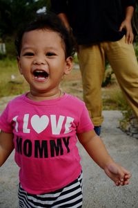 Portrait of happy boy standing outdoors