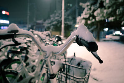 Snow on bicycle in city