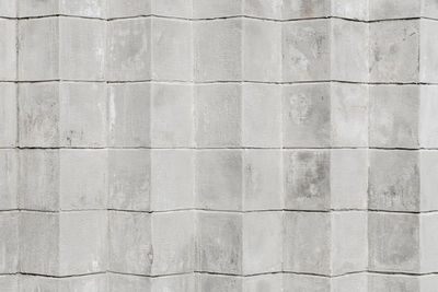 Grey or white concrete or cement brick background, cubes embedded