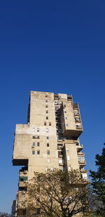 Low angle view of building against clear blue sky