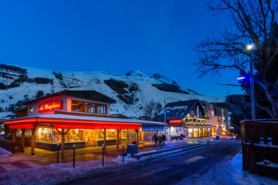 Illuminated building against sky during winter at night