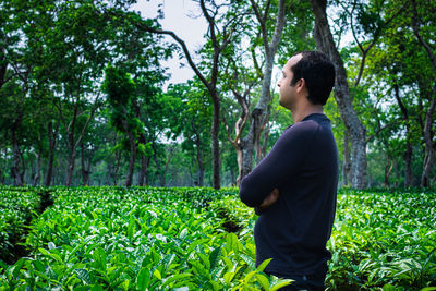 Man standing at tea garden closeup shot with blurred background at day from flat angle