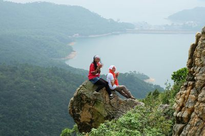 People on mountain against sky