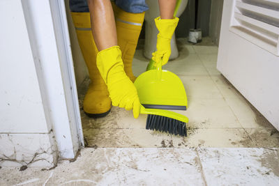 Low section of women standing on tiled floor