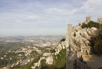 Panoramic view of people on mountain against sky