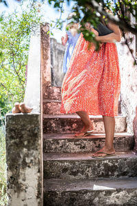 Woman standing by staircase