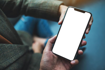Midsection of woman using mobile phone