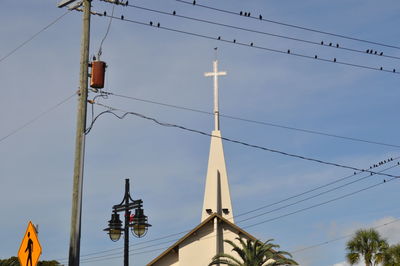 Low angle view of telephone pole against sky