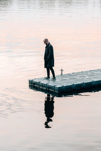 Full length of man fishing in lake