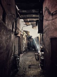 Narrow alley amidst buildings in city