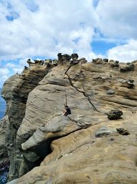 Low angle view of rock formation against sky