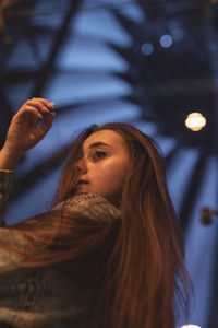 Low angle view of young woman looking away