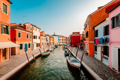 Burano canal with colorful houses at sunset