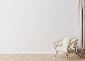 Room with parquet floor, white wall and empty space. rattan armchair, basket. mock up interior