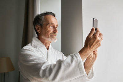 Senior man doing selfie at home