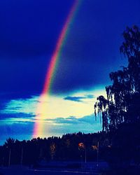 Rainbow over landscape against sky