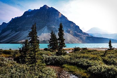 Scenic view of sea and mountains against sky