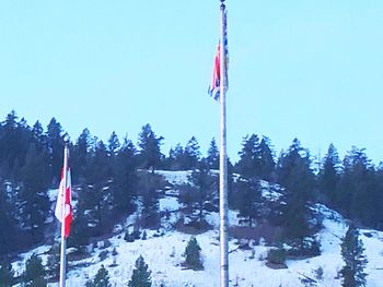 Flag on built structure against clear sky