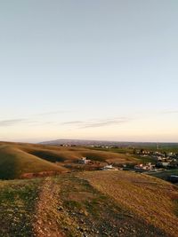 Scenic view of field against clear sky during sunset