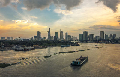 View of city at waterfront during sunset