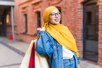 Portrait of beautiful woman standing on street