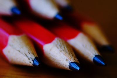 Close-up of red pencils on table
