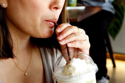 Midsection of woman holding ice cream