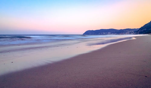 Scenic view of beach against sky during sunset