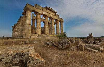 Old ruins of building against cloudy sky