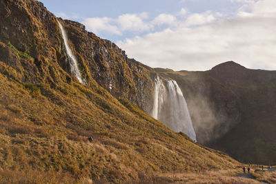 Scenic view of waterfall against sky